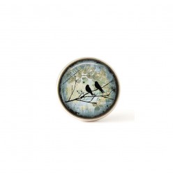 Interchangeable clip on buttons birds on a branch teal background