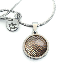 Stainless steel necklace with a rose gold chevron theme on a gray background